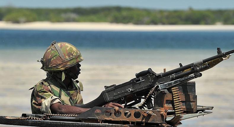 A Kenyan Defence Force soldier keeps lookout on the coast near Burgabo village, Southern Somalia on December 14, 2011. Burgabo is a Somalian port village which has been secured by Kenyan forces as they advance further up the Somali coastline in search of Al-Shabaab fighters. AFP PHOTO/Carl de Souza (Photo by CARL DE SOUZA/AFP via Getty Images)