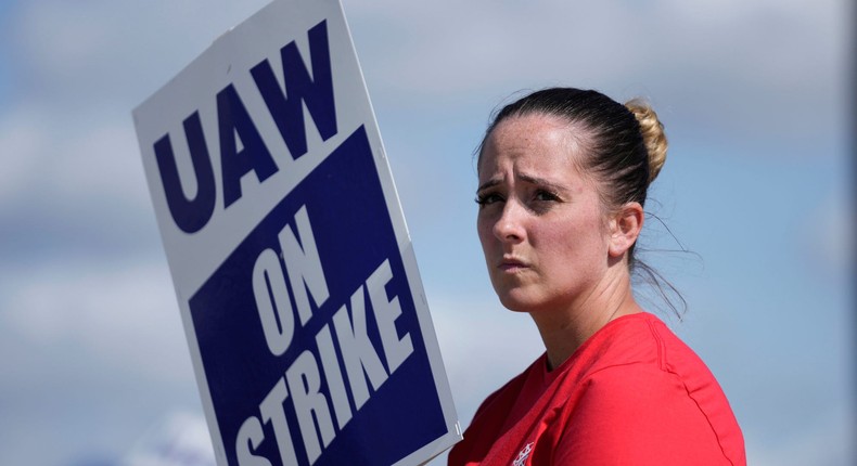 United Auto Workers member Victoria Hall walks the picket line at the Ford Michigan Assembly Plant in Wayne, Mich., Monday, Sept. 18, 2023. So far the strike is limited to about 13,000 workers at three factories — one each at GM, Ford and Stellantis.AP Photo/Paul Sancya