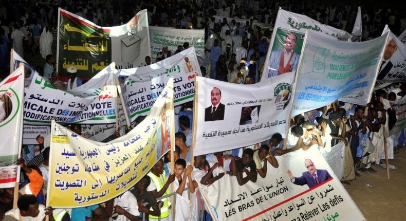 This photo taken on July 20, 2017 shows supporters of Mauritanian President gathering and holding banners during a rally ahead of the constitutional referendum on scrapping the senate and changing the national flag, in Nouakchott