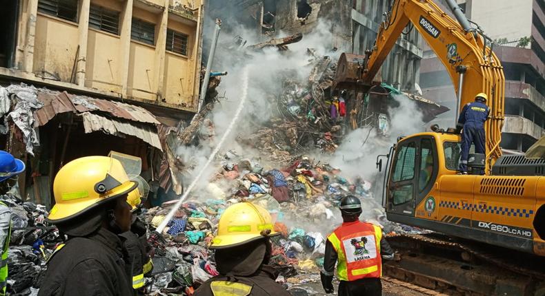 Men of Lagos State Fire Service and other emergency officials at the scene of the fire disaster at Mertins Street, Lagos on Wednesday (NAN)