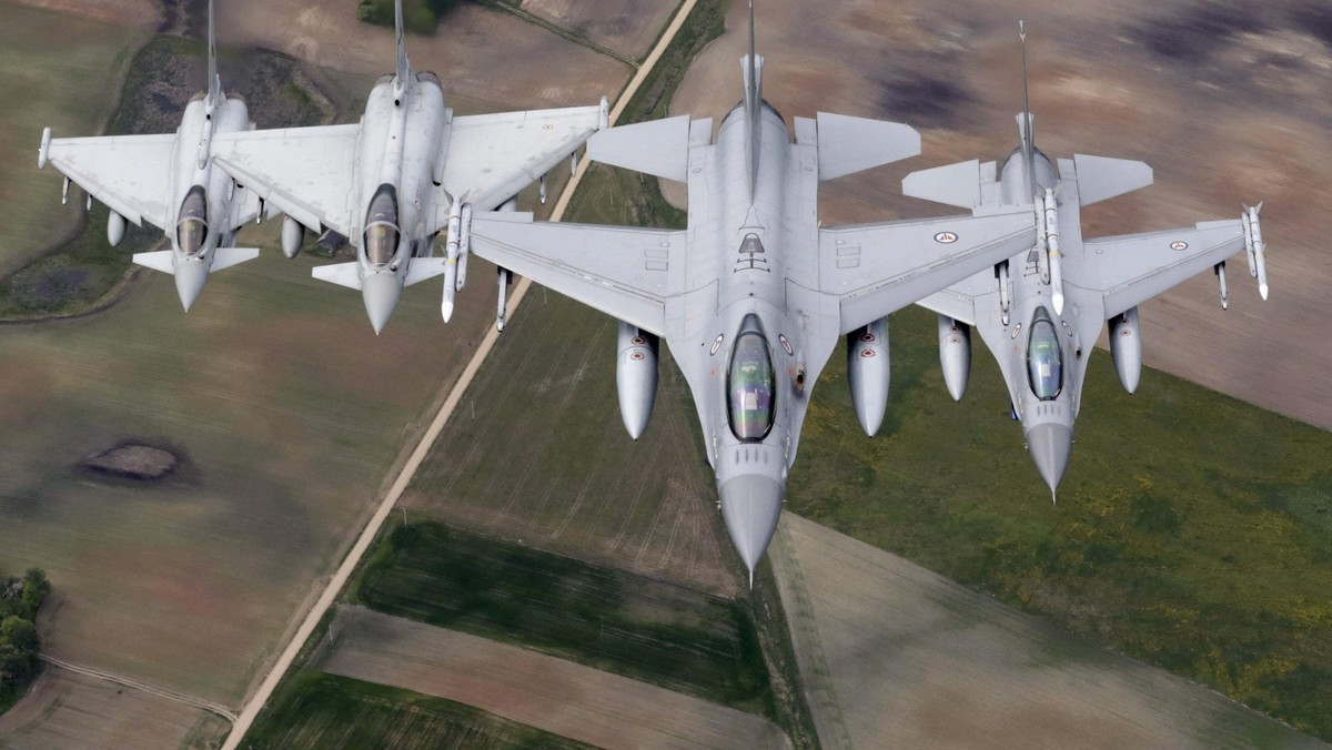 Norwegian Air Force's F-16 fighters and Italian Air Force's Eurofighter Typhoon fighters patrol over the Baltics during a NATO air policing mission from Zokniai air base near Siauliai