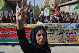 Kurdish and Arab protesters chant slogans against Turkish President Tayip Erdogan as they walk during a march to the United Nations Headquarters in the town of Qamishli