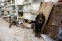 A grave cleaner sits on a coffin next to a mummified body during the exhumation work at the General Cemetery in Guatemala City