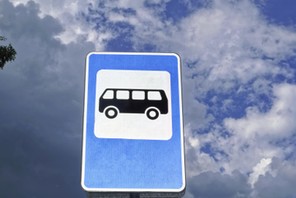 Bus stop road sign on background of blue sky.