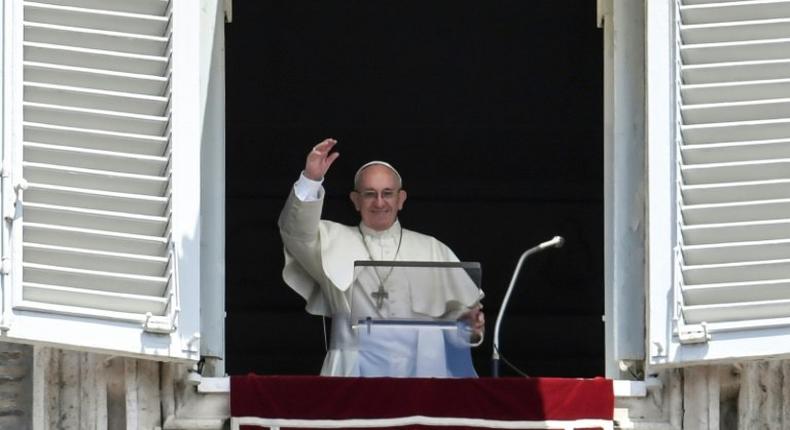 Pope Francis waves at the crowd during the Angelus prayer at the Vatican, on July 2, 2017