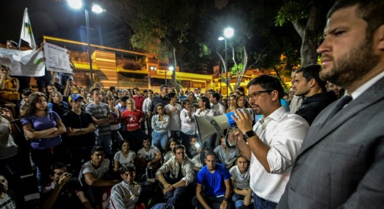 The first vice president of Venezuela's National Assembly, Freddy Guevara addresses marchers paying tribute to student Juan Pablo Pernalete, killed on April 26 by the impact of a gas grenade during a protest, in Caracas, on April 29, 2017