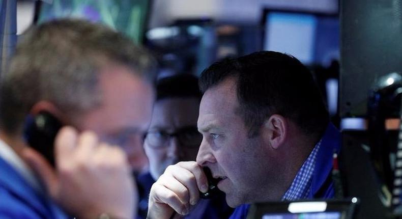 Traders work on the floor of the NYSE