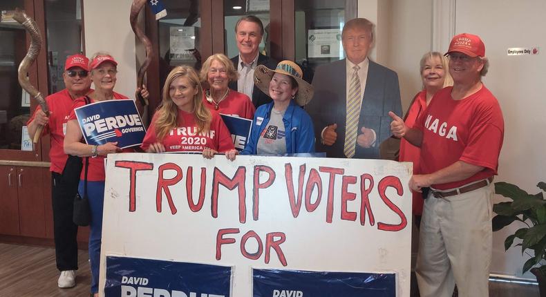 Georgia gubernatorial hopeful David Perdue poses alongside a cardboard cutout of former President Donald Trump during a campaign stop in Augusta, Georgia on Friday, May 20.