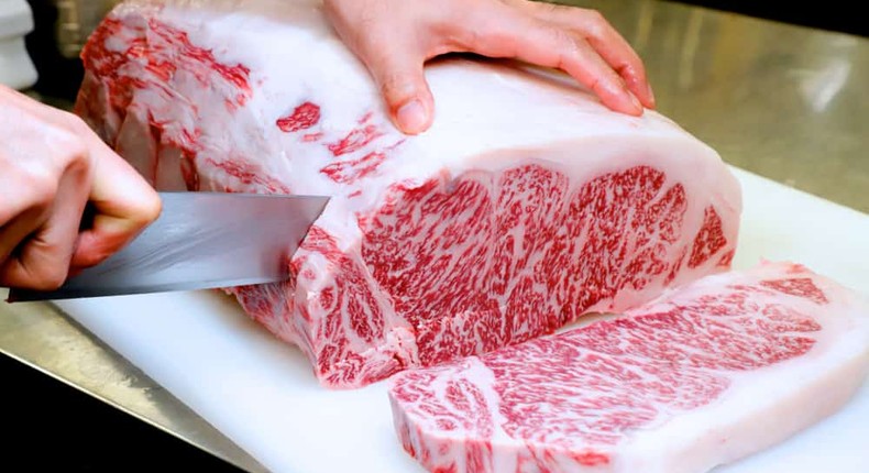 Chef cutting raw Japanese wagyu beef