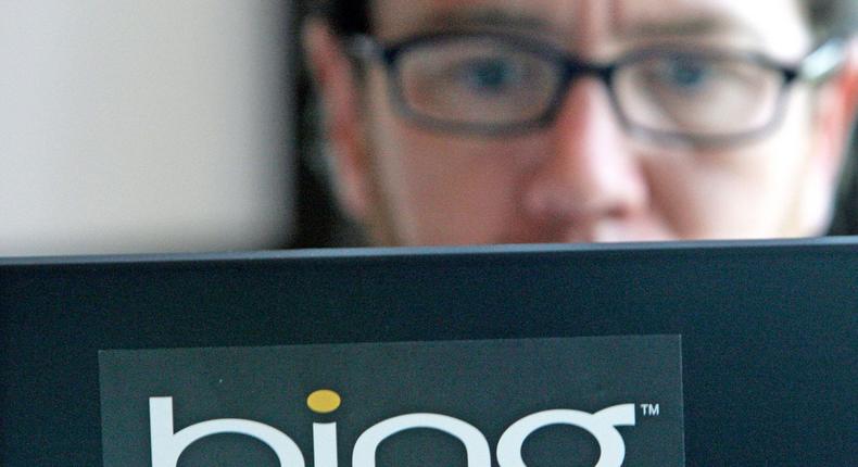 Vendor Patrick Porter works on a laptop marked with the logo for Bing, Microsoft's recently upgraded search engine, in a cafeteria at Microsoft in Redmond, Wash., Wednesday, July 29, 2009. The extended reach Microsoft Corp. is gaining with its new partnership with Yahoo Inc. will let it introduce Bing to more people.AP Photo/Elaine Thompson