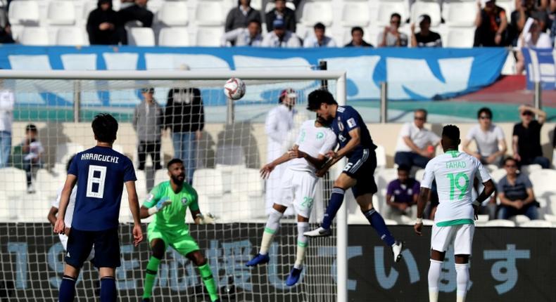 Takehiro Tomiyasu (2nd-R) headed home from a corner to send Japan through to the last eight