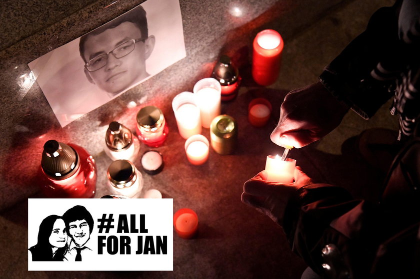 A journalist lights a candle in memory of murdered investigative journalist Jan Kuciak, in Trencin