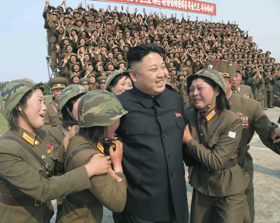 North Korean leader Kim Jong Un greeting a women's subunit during a rocket-launching drill