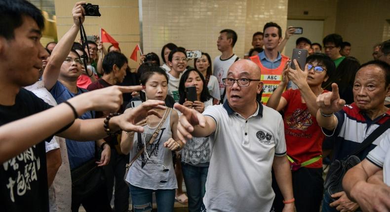 A group of men, many waving Chinese flags, attacked people perceived to be pro-democracy protesters