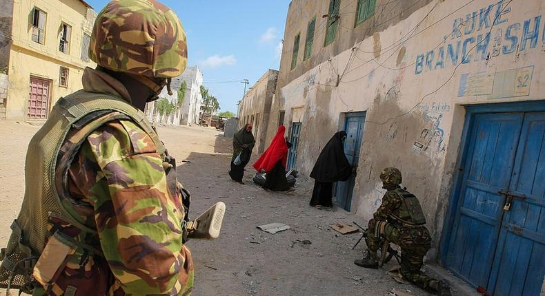 In a handout photograph taken on October 5, 2012 and released by the African Union-United Nations Information Support Team 6 October, soldiers of the Kenyan Contingent serving with the African Union Mission in Somalia (AMISOM) stand guard on a street in the centre of the southern Somali port city of Kismayo adjacent to the old police station while a combat engineering team inspects the surrounding area following reports of a suspected improvised explosive device (IED) left behind by the Al-Qaeda-affiliated extremist group Al Shabaab. (STUART PRICE/AFP/GettyImages)