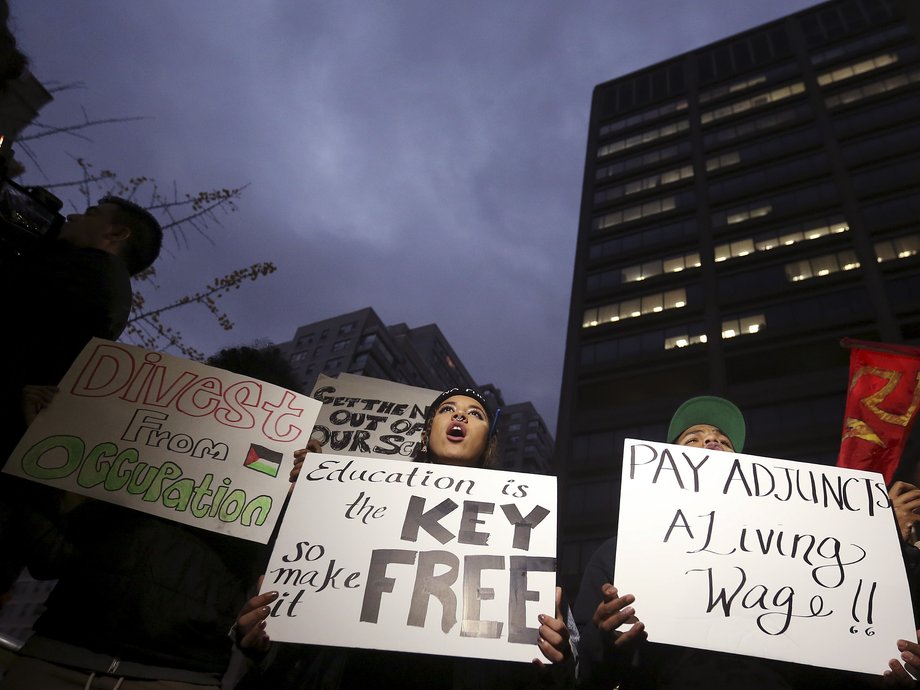 Students hold up signs and chant slogans as they attend a demonstration calling for lower tuition at Hunter College in the Manhattan borough of New York Nov. 12, 2015.