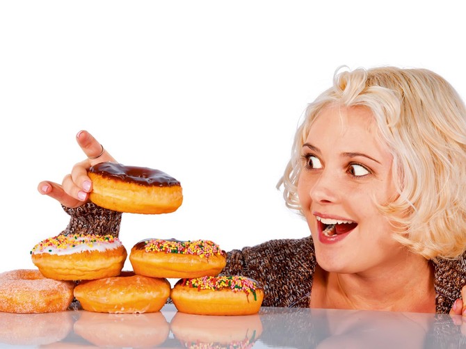 19363_stock-photo-woman-steals-a-donut-off-a-pile-of-donuts-shutterstock_68708107