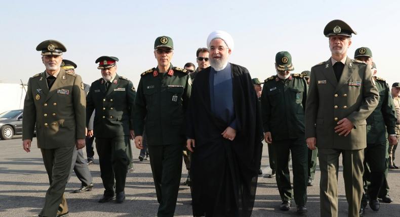 A handout picture provided by the Iranian presidency on Sunday shows President Hassan Rouhani (C) with top military officials