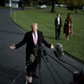 U.S. President Donald Trump talks with the reporters as First Lady Melania Trump and her son Barron 