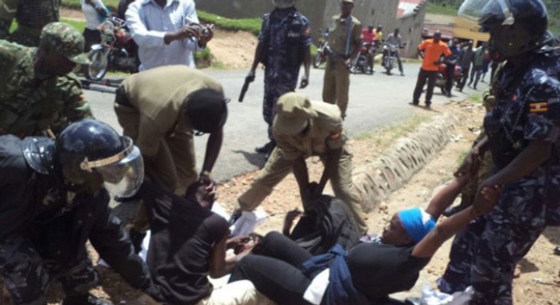 Two people being manhandled by Police. The UN is demanding that an independent body investigates torture claims by security operatives in Uganda