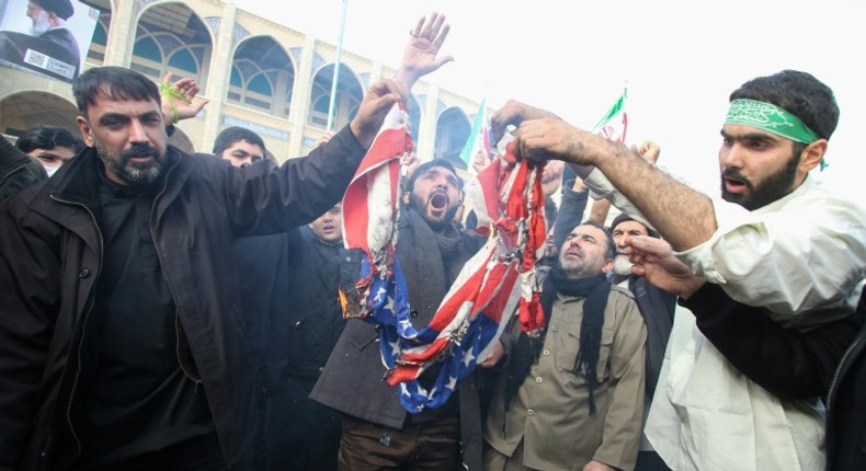 Iranians burn a US flag during a demonstration against American crimes in Tehran  following the killing of Iranian Revolutionary Guards Major General Qasem Soleimani in a US strike on his convoy at Baghdad international airport