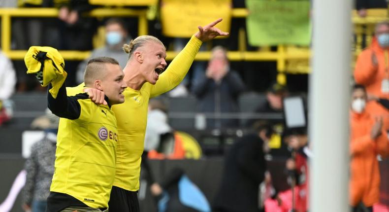 Dortmund's Norwegian forward Erling Braut Haaland celebrates with a fan after scoring twice against Mainz on Saturday Creator: Ina Fassbender