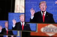 Republican U.S. presidential nominee Donald Trump is shown on TV monitors in the media filing room d