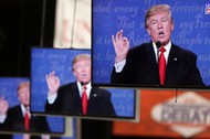 Republican U.S. presidential nominee Donald Trump is shown on TV monitors in the media filing room d