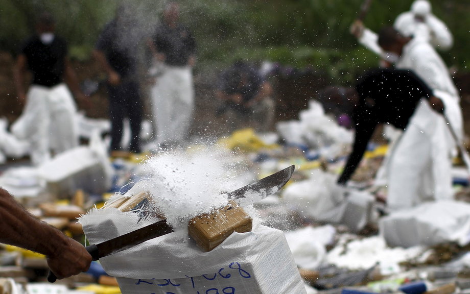 A national police member destroys drug packages before incinerating them in Panama City, July 23, 2015.