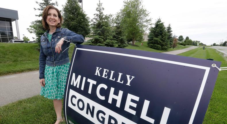 Indiana State Treasurer Kelly Mitchell stands by a campaign sign, Thursday, May 28, 2020, in Westfield, Ind. Mitchell is a candidate for Indiana's 5th Congressional District. More Republican women than ever are seeking House seats this year after the 2018 election further diminished their limited ranks in Congress. But so far it appears that any gains this November could be modest.  (AP Photo/Darron Cummings)