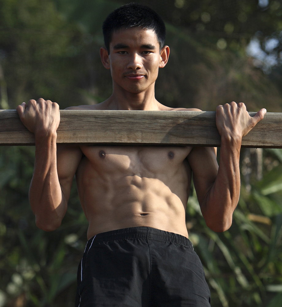 A young man exercises during training in Pokhara, Nepal.
