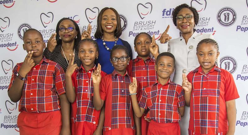L-R: Corporate Affairs & Sustainable Business Director, Unilever Ghana and Nigeria, Soromidayo George; Category Manager (Oral Care), Unilever Nigeria, Toluwaleke Salu; President, Nigerian Dental Association (NDA), Dr Evelyn Eshikena, and pupils of Hallmark Nursery & Primary School, Ikeja during Pepsodent 2019 World Oral Health Day press briefing/oral health awareness walk held in Lagos…on Wednesday.  