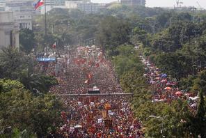A Philippine flag flutters as devotees parade the black statue of Jesus Christ during the annual Bla