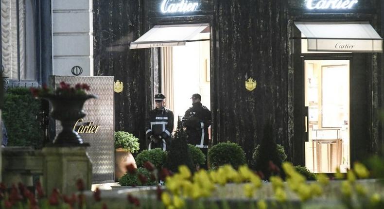 Police officers stand guard in front of the Cartier jewellery boutique after it was robbed in downtown Monaco