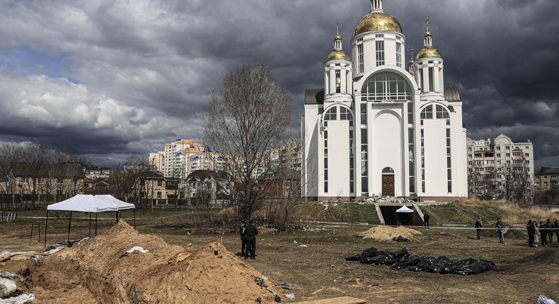 Officials exhume the bodies of civilians who died during Russian attacks from mass graves in Bucha, Ukraine.