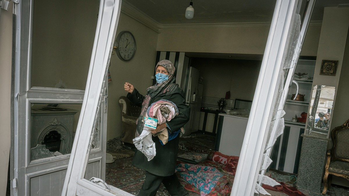 Žena sakuplja stvari iz kuće oštećene kada je obližnja stambena zgrada pogođena u napadu tokom noći u Tabrizu