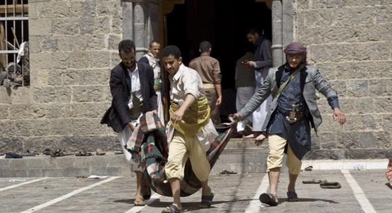 Yemenis carry a body of a man killed in a bomb attack in a mosque in Sanaa, Yemen, Friday, March 20, 2015. 