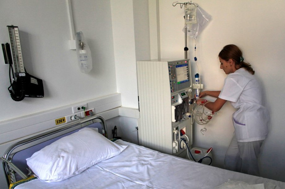 Nurse Georgiana Stefan prepares a dialysis machine for a patient.