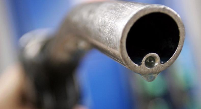 A motorist holds a fuel pump at a Gulf petrol station in London,  file. REUTERS/Luke MacGregor/File Photo