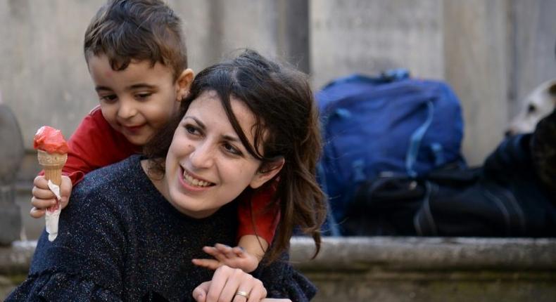 Syrians Nour and her son Riad are among the 12 refugees taken in by Pope Francis from a refugee camp a year ago