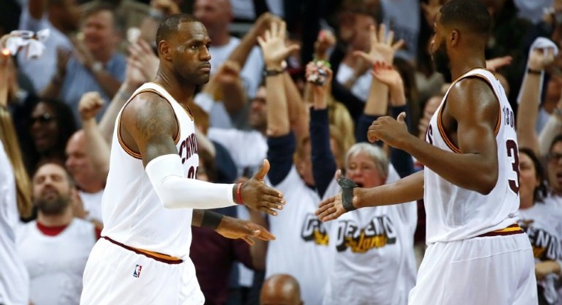 LeBron James (L) and Tristan Thompson of the Cleveland Cavaliers celebrate their 109-108 win over the Indiana Pacers in Game One of the Eastern Conference quarter-finals during the 2017 NBA Playoffs, at Quicken Loans Arena in Cleveland, on April 15