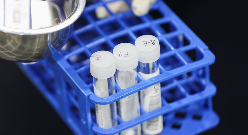 A medical worker carries RT-PCR swab tests at a pre-departure coronavirus disease (COVID-19) testing facility, as countries react to the new coronavirus Omicron variant, outside the international terminal at Sydney Airport in Sydney, Australia, November 29, 2021.