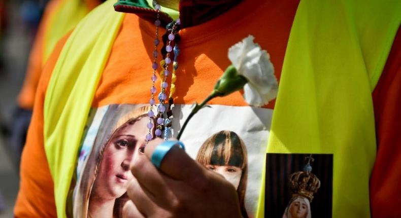 A pilgrim sports a T-shirt with the image of Our Lady of Fatima ahead of a visit by Pope Francis to the shrine in central Portugal