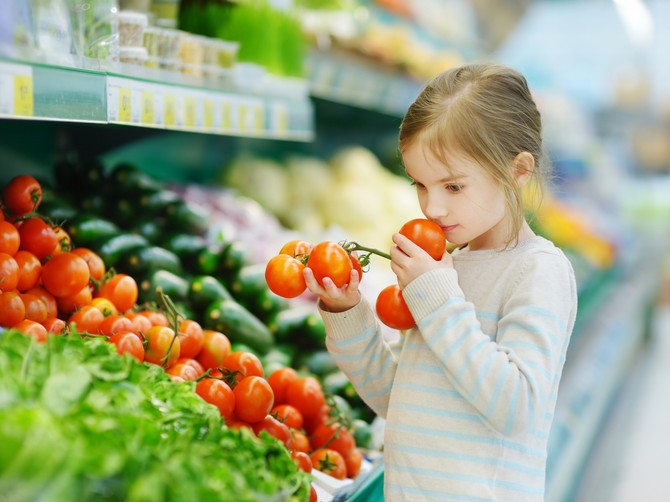 stock-photo-little-girl-choosing-tomatoes-in-a-food-store-or-a-supermarket-298593938