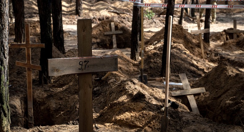 Unidentified graves of civilians and Ukrainian soldiers in a cemetery during an exhumation in the recently retaken area of Izium, Ukraine, September 17, 2022.