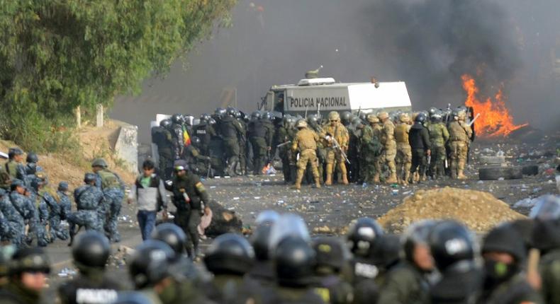 Bolivian riot police and soldiers clash with supporters of ex-President Evo Morales during a protest in the Cochabamba department  on November 15