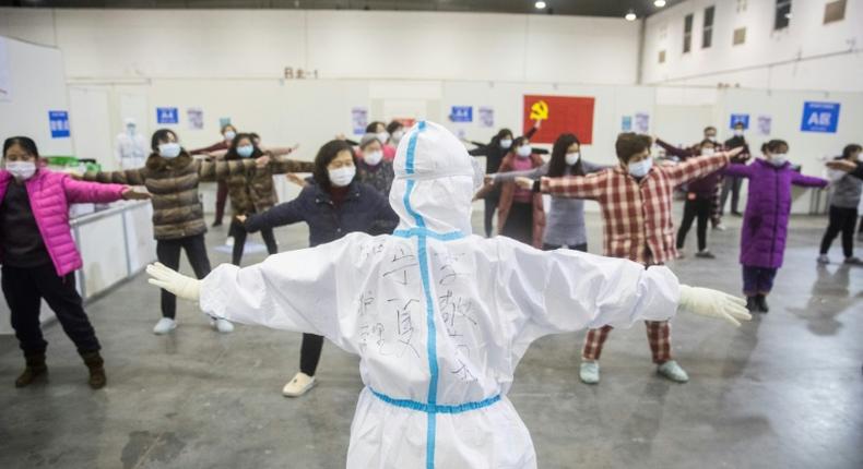 Medical staff in Wuhan, the centre of China's coronavirus outbreak, lead patients in group exercises at a hospital