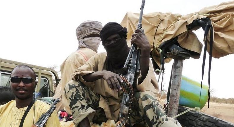 Militiaman from the Ansar Dine Islamic group sit on a vehicle in Gao in northeastern Mali, June 18, 2012. 