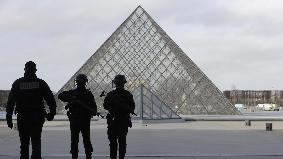 French police secure the site near the Louvre Pyramid in Paris