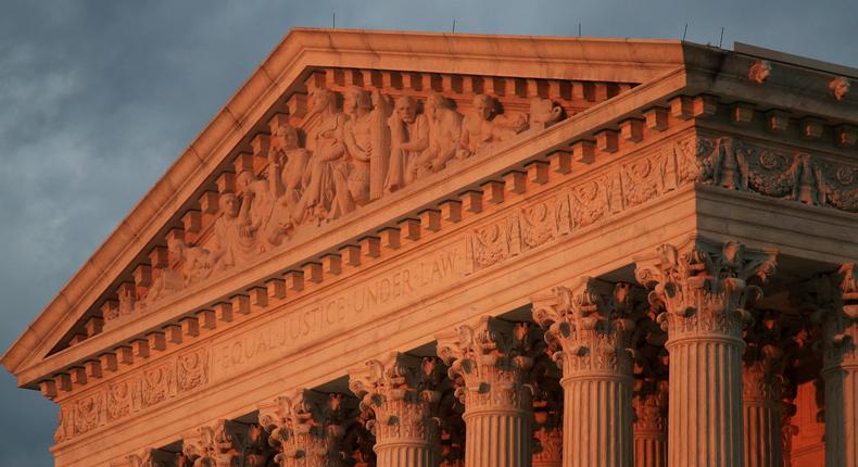 FILE - This Oct. 4, 2018, file photo shows the U.S. Supreme Court at sunset in Washington. More than 200 corporations have signed a friend-of-the-court brief urging the U.S. Supreme Court to rule that federal civil rights law bans job discrimination on the basis of sexual orientation and gender identity. The brief, announced Tuesday, July 2, 2019 by a coalition of five LGBTQ-rights groups, is being submitted to the Supreme Court this week ahead of oral arguments before the justices this fall on three cases that may determine whether gays, lesbians and transgender people are protected from discrimination by existing federal civil rights laws. (AP Photo/Manuel Balce Ceneta, File)